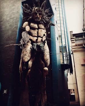 Installation art piece blending natural elements and urban materials in a vacant space.