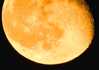 Close-up of a golden moon photo art showing intricate details of the moon's surface and surrounding landscape.