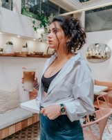 A serene scene of a woman sipping coffee in a chic cafe.