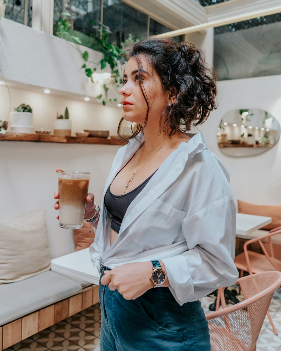 woman in white button up shirt and blue denim jeans sitting on chair