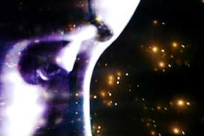 Close-up of a hyper-detailed AI-generated portrait with glowing eyes and sleek shadows