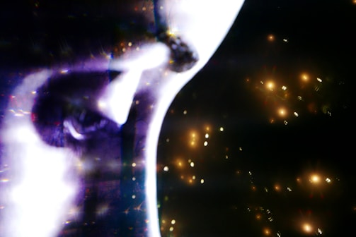 Stylized face recognition scan from a photo using AI, highlighted with futuristic neon blue and purple lights.