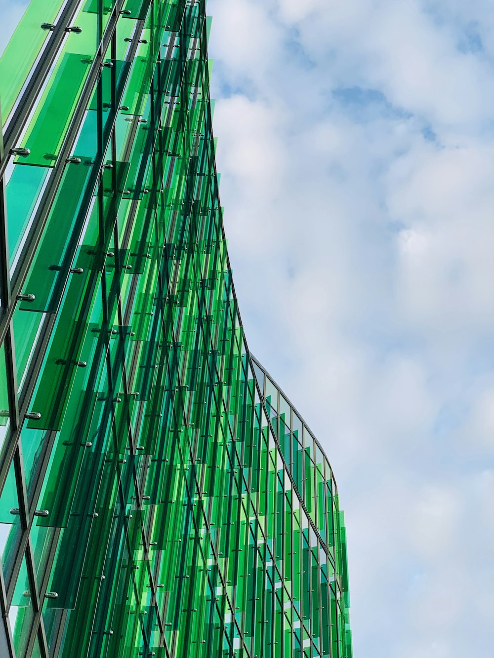 green glass walled high rise building