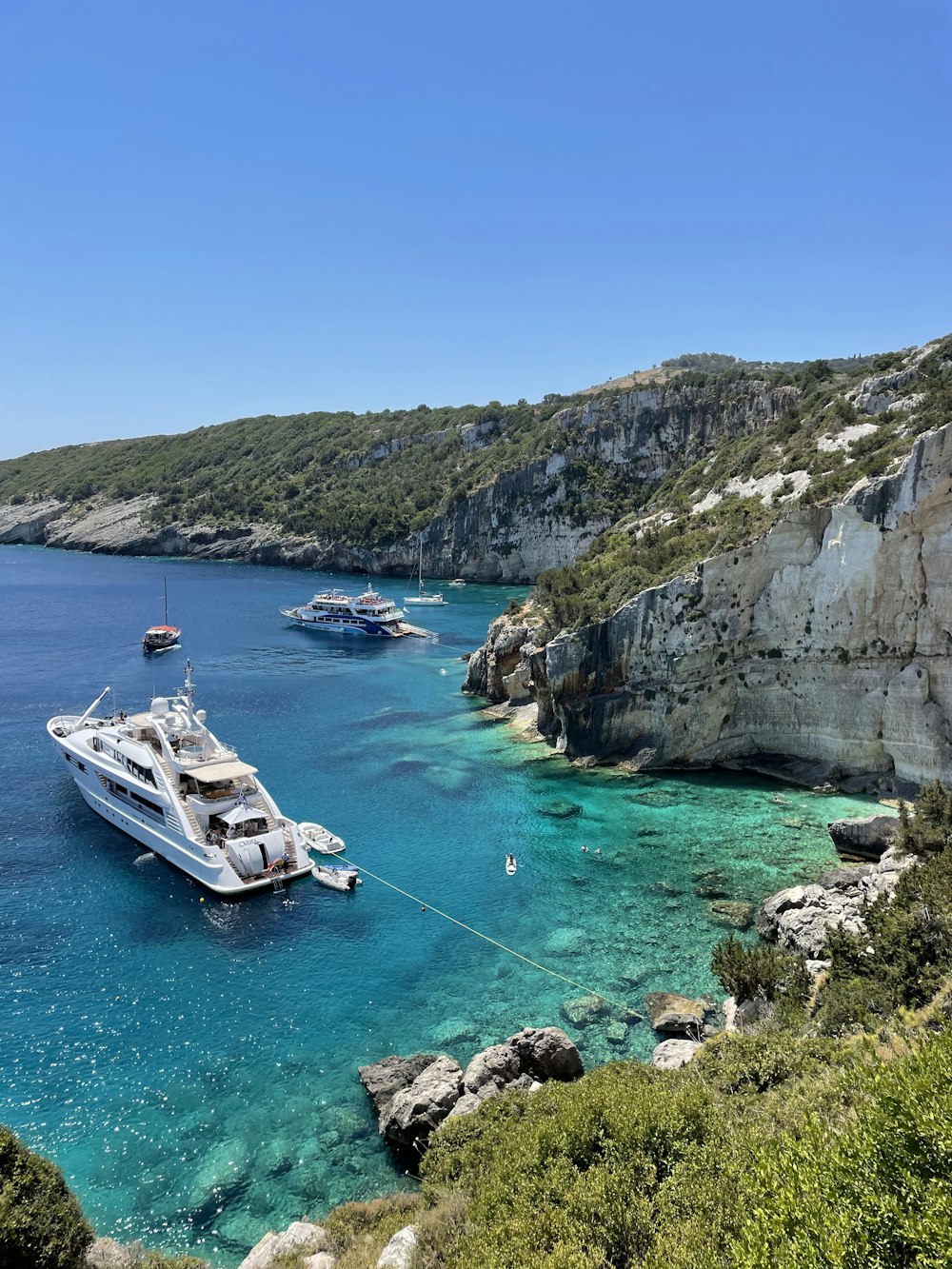 a boat in a body of water near a cliff