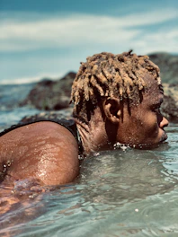 woman in black bikini top in water