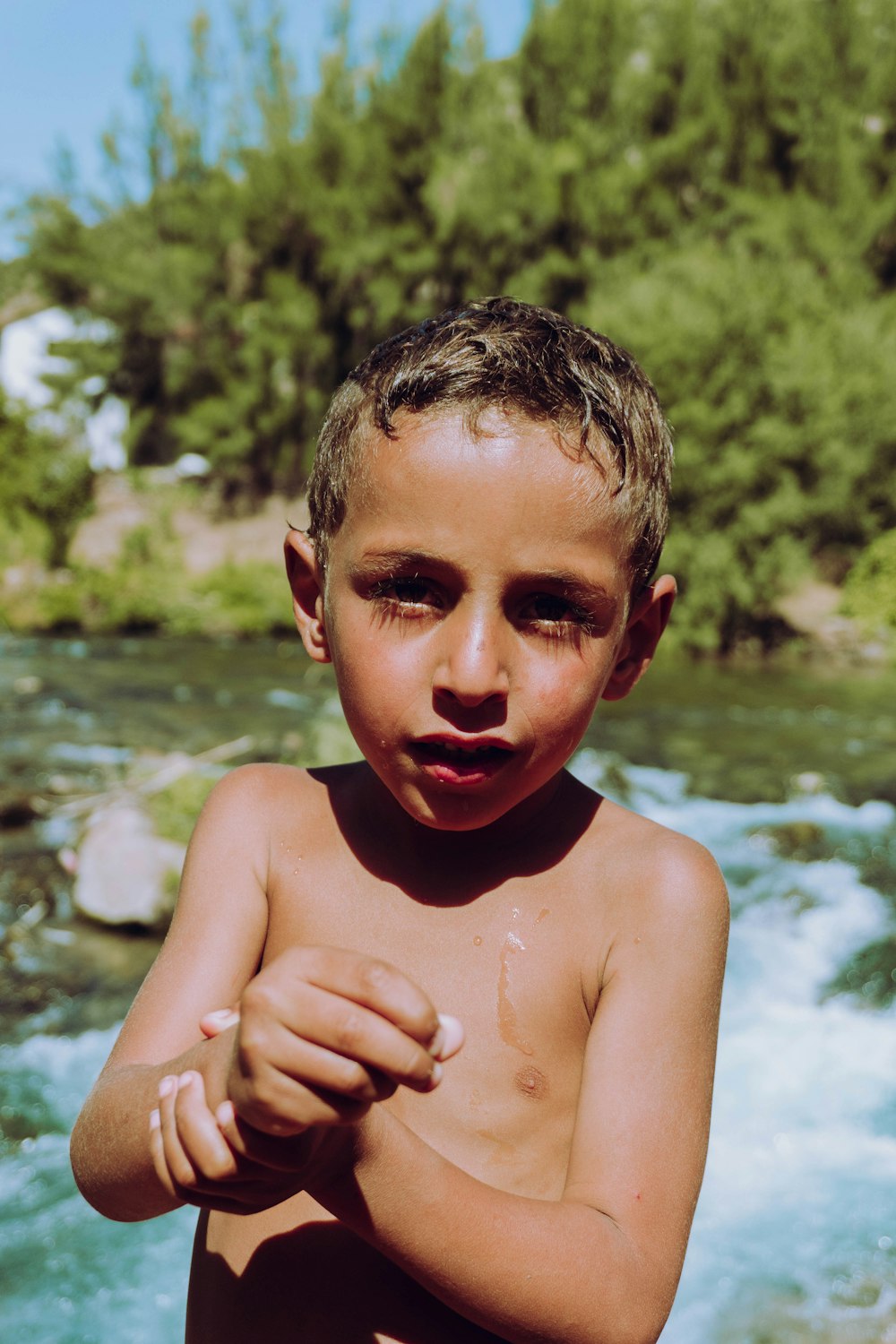 topless boy with tongue out