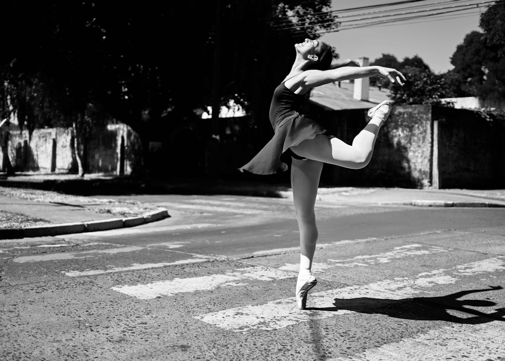 woman in black dress dancing on street