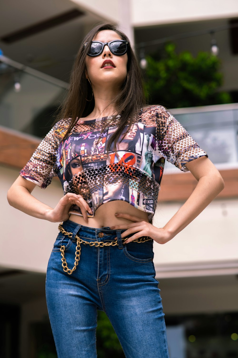 woman in red and white floral shirt and blue denim jeans
