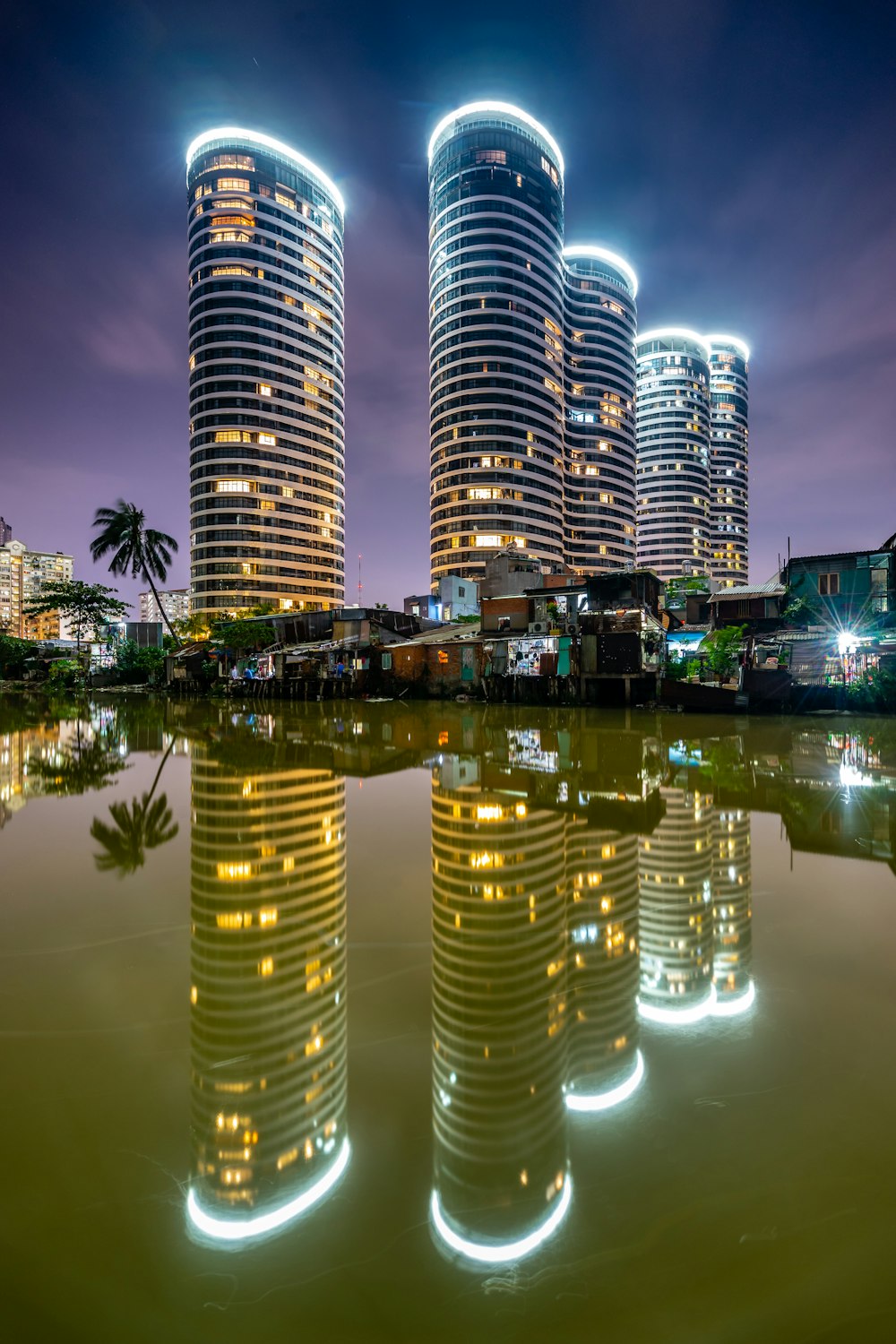 reflection of lighted buildings on water during night time