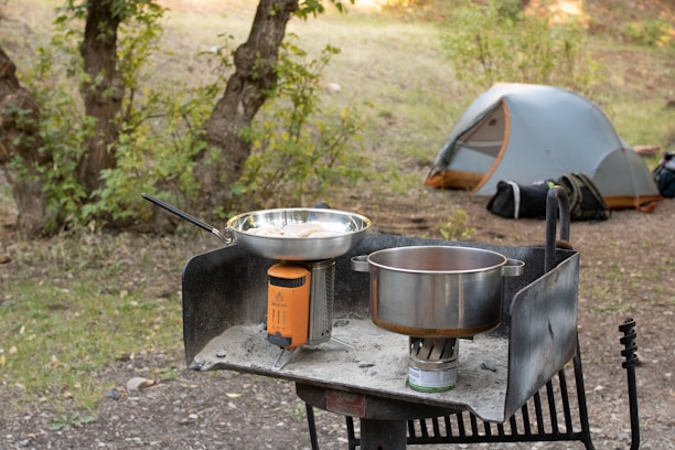 stainless steel cooking pot on black stove