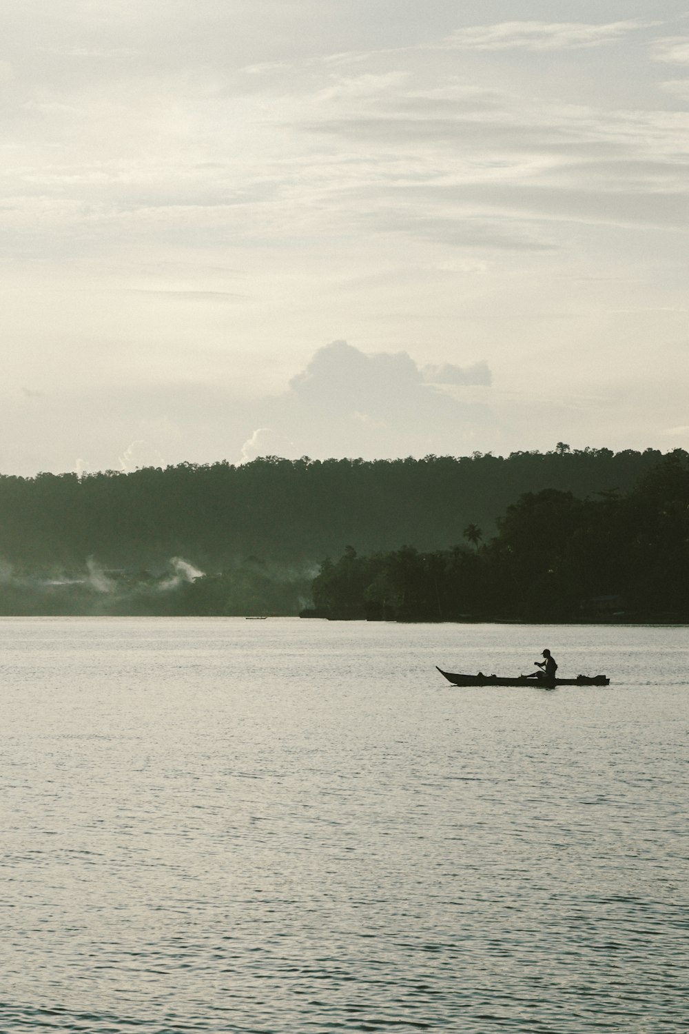 person riding on boat on body of water during daytime