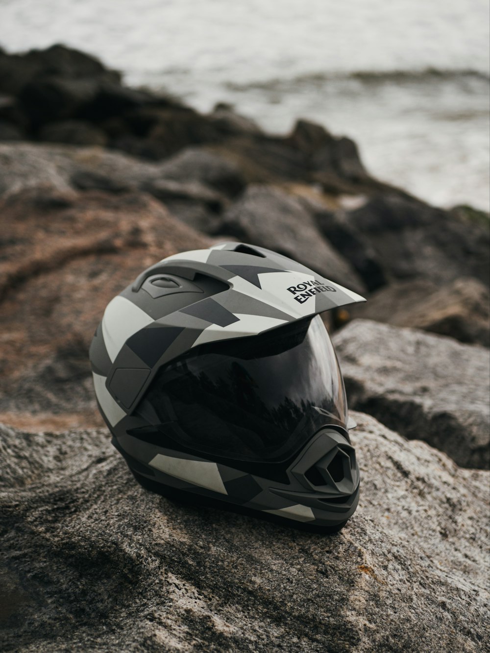 black and white helmet on brown rock