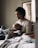 A mother reading a book with her child in a cozy setting.
