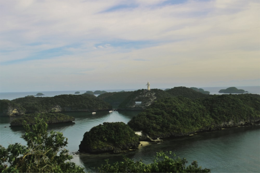 green island surrounded by body of water during daytime