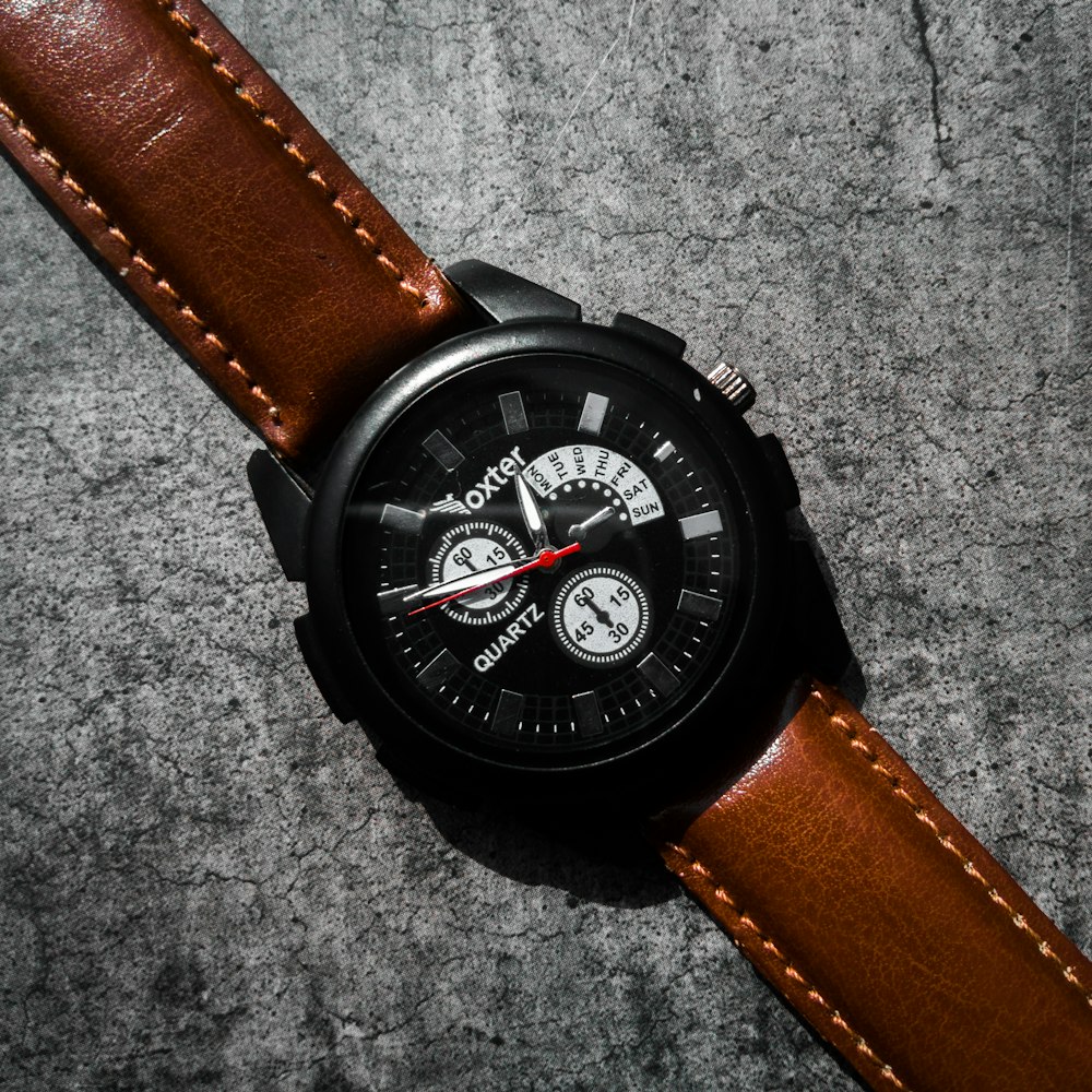 brown leather strap black chronograph watch