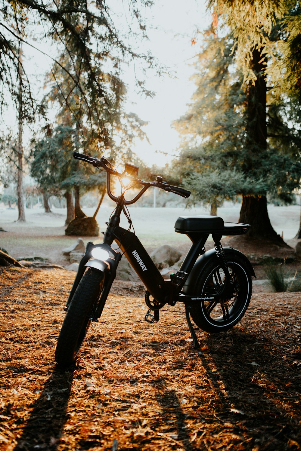 black and white bicycle on brown dirt road during daytime