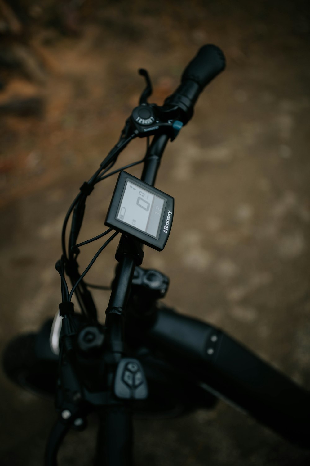 black and gray bicycle with black and white digital device