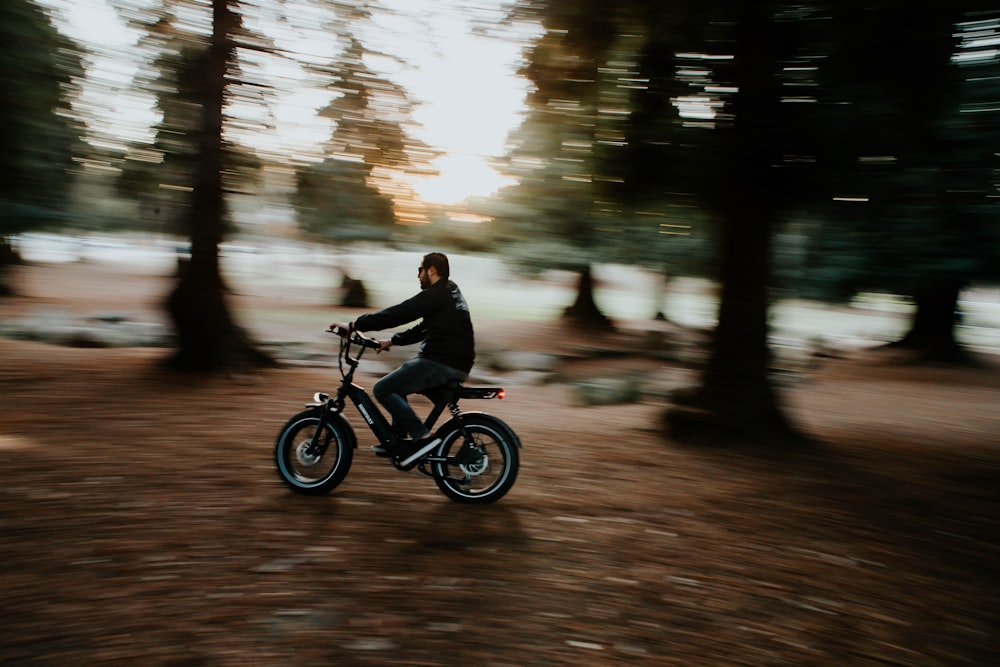 man in black jacket riding on black motorcycle in the middle of the road during daytime