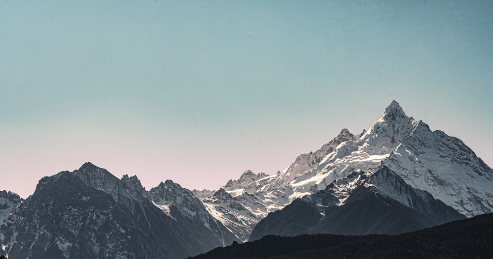 snow covered mountains under blue sky during daytime