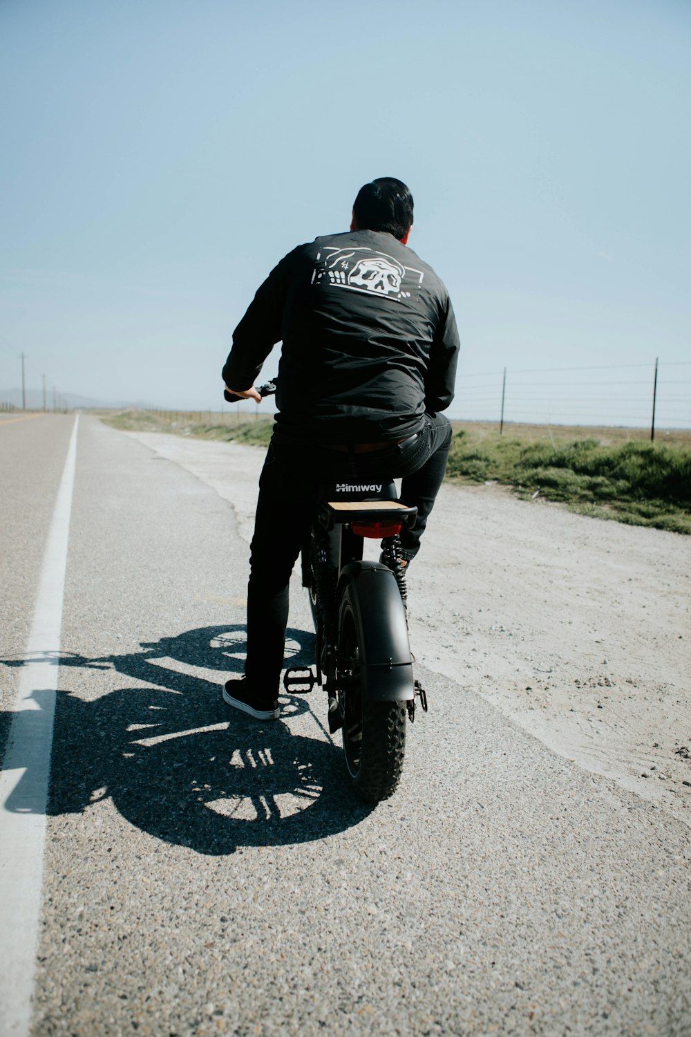 man in black jacket riding motorcycle on road during daytime