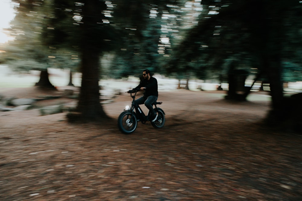 man in black jacket riding on black motorcycle on road during daytime