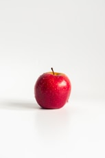 red apple on white surface