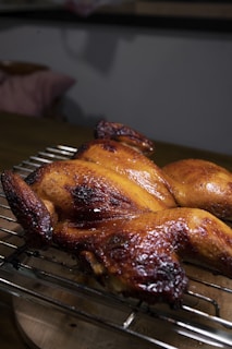 roasted chicken on black metal grill