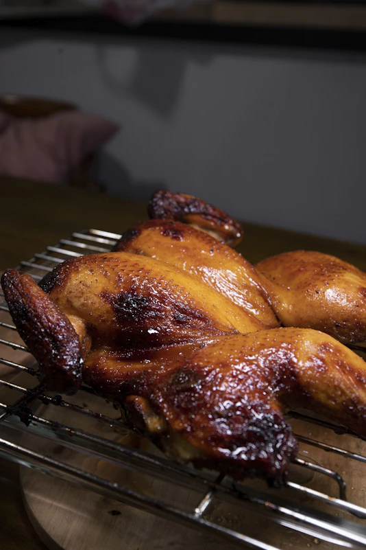 roasted chicken on black metal grill