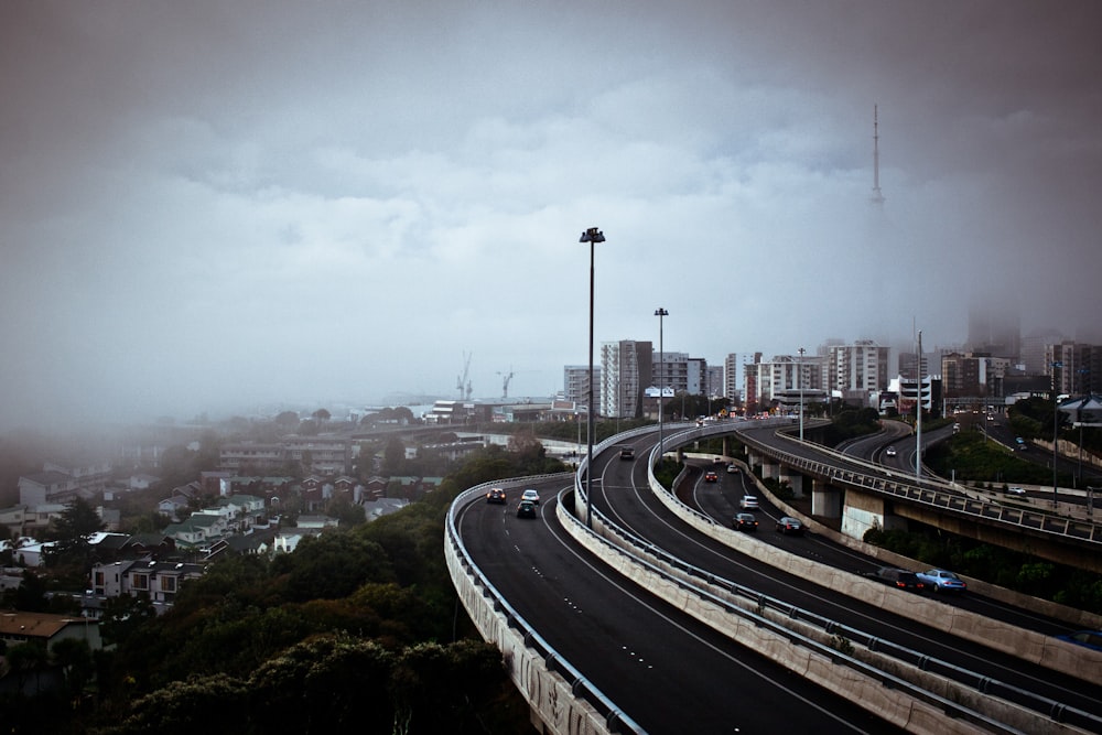 city buildings and roads under white sky during daytime