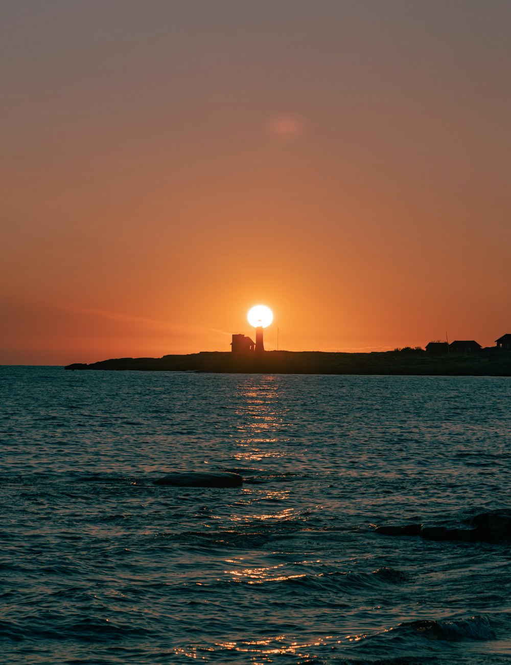 silhouette of island during sunset