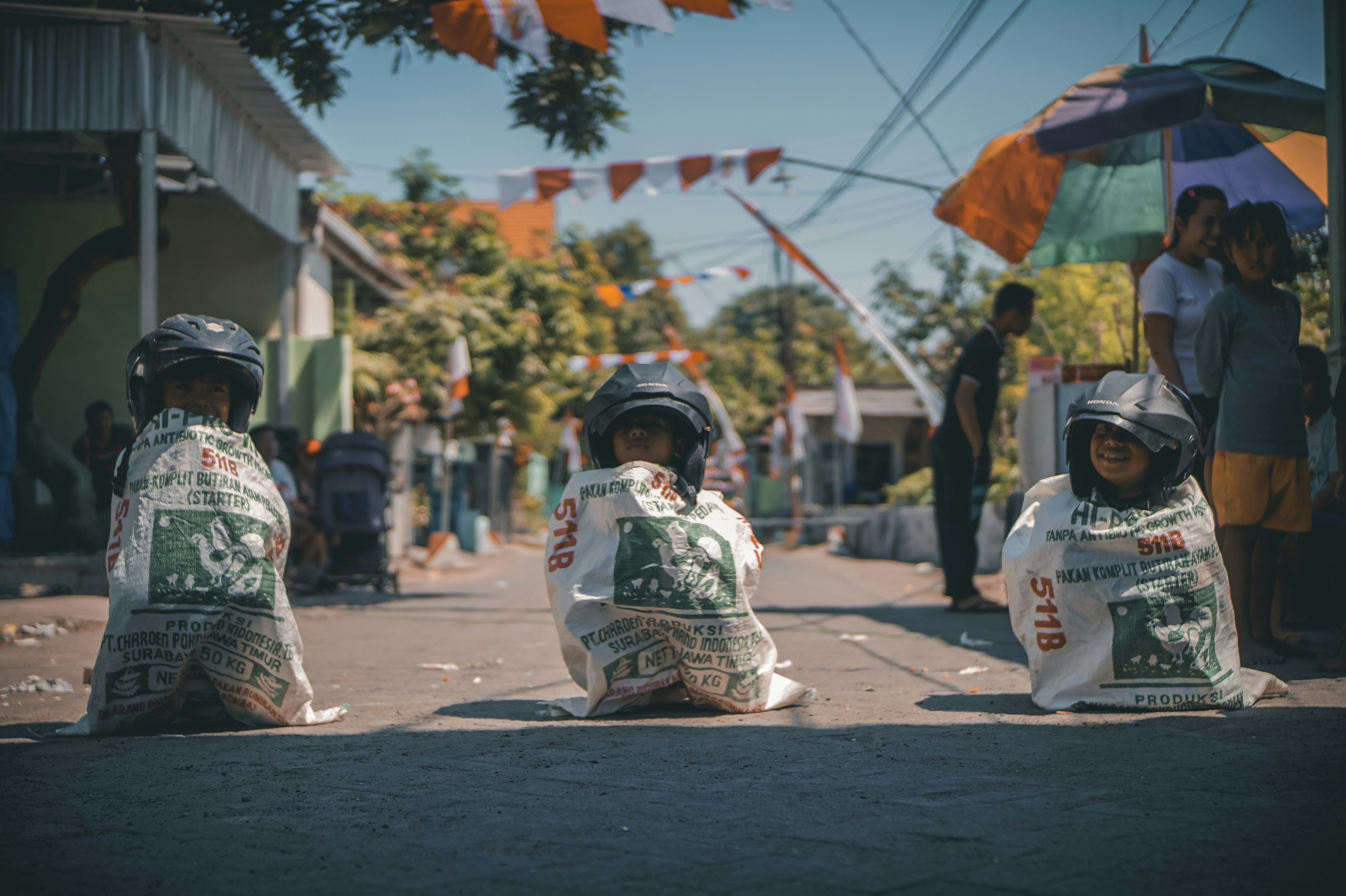 a couple of kids sitting on the side of a road