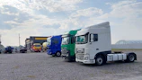 white and green truck on gray asphalt road during daytime