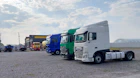 white and green truck on gray asphalt road during daytime