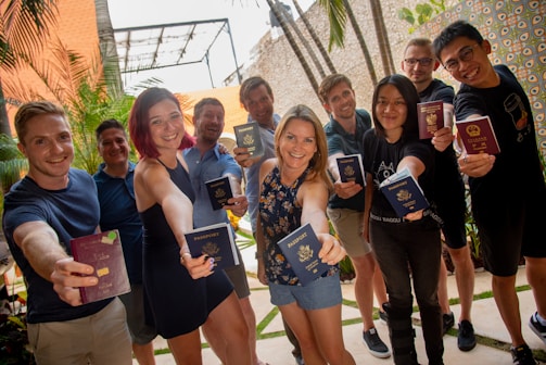 group of people standing near green plant