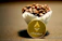 Close-up of a steaming cup of dark coffee with a bitcoin logo mug beside a laptop.