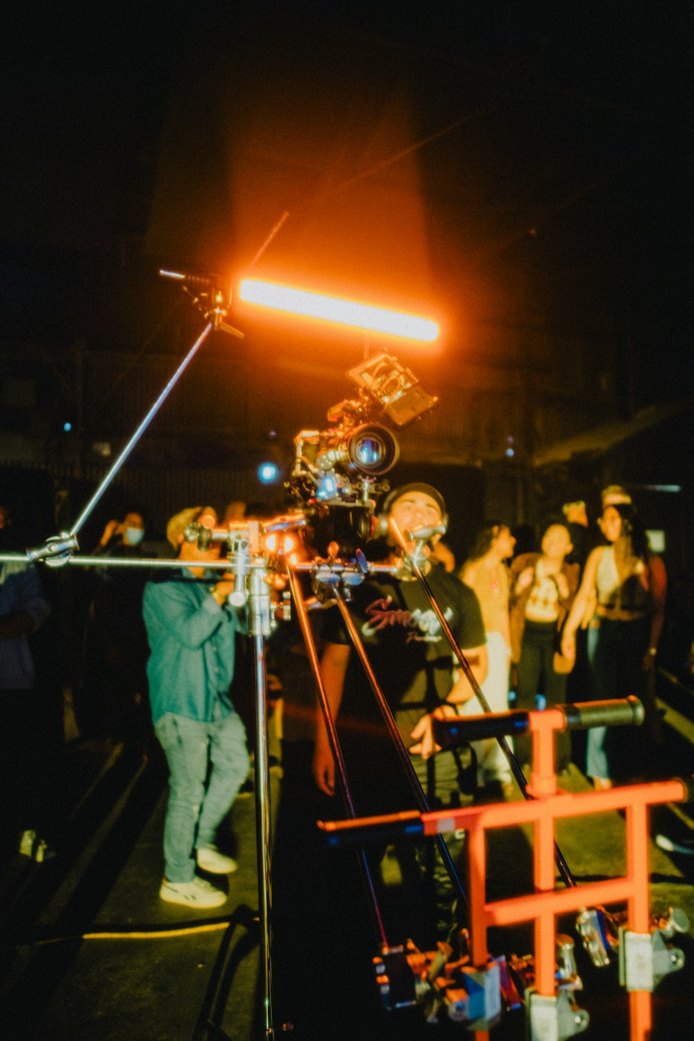 man in black suit singing on stage