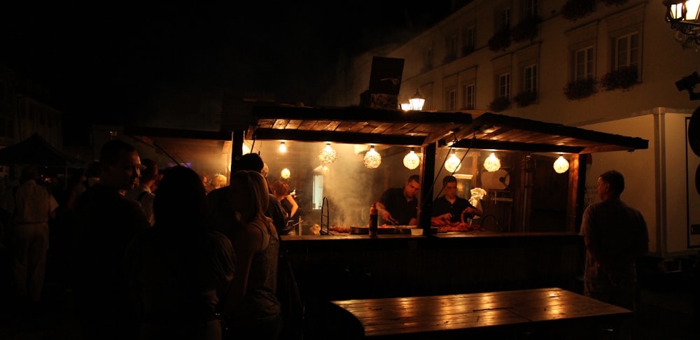 people standing in front of store during night time