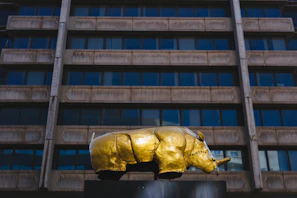 Close-up of a rhinoceros sculpture symbolizing strength and stability in a luxury lobby.