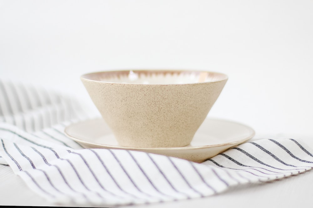 white ceramic cup on white ceramic saucer