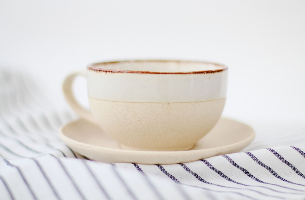 white ceramic teacup on white ceramic saucer