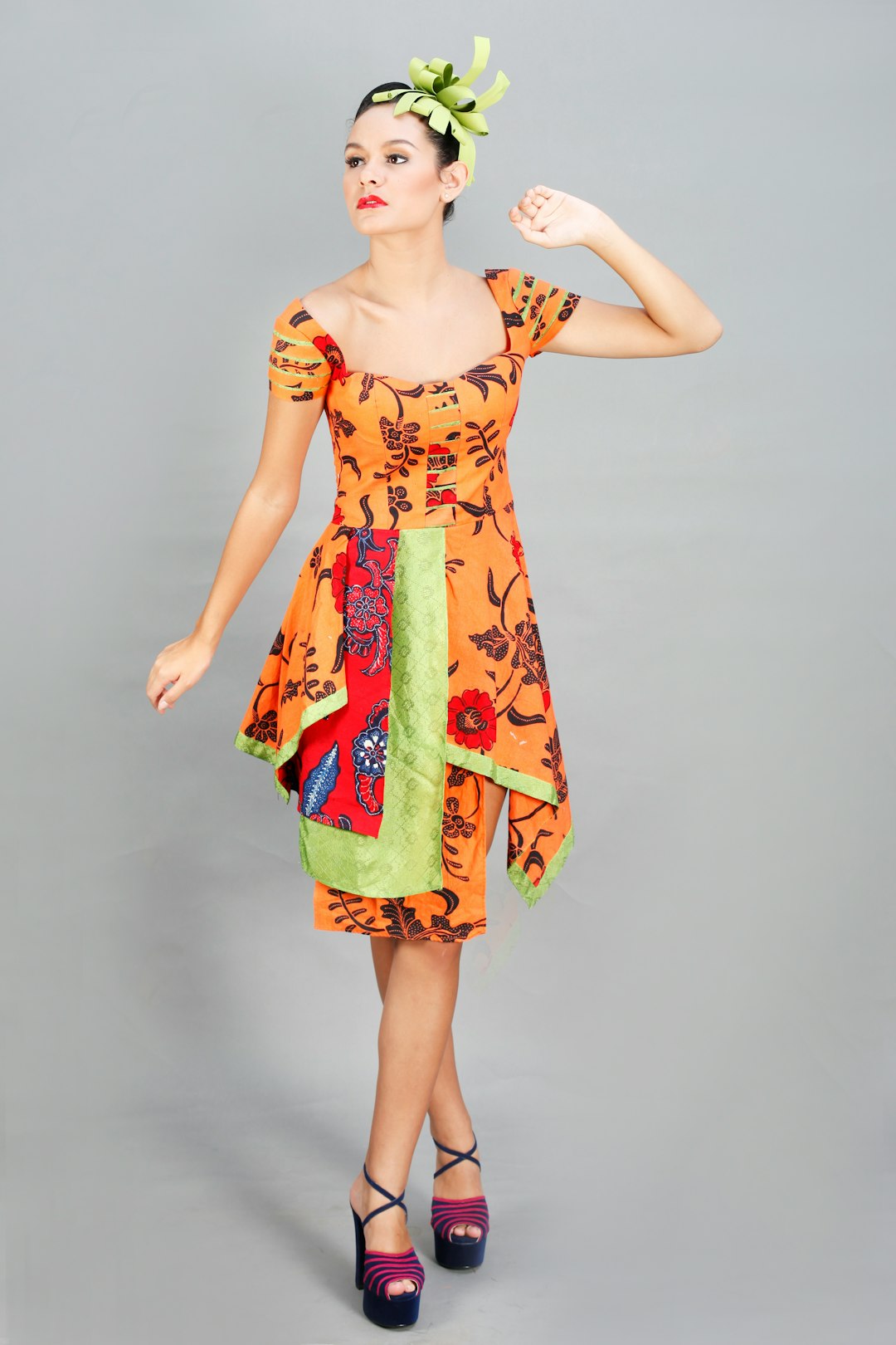 woman in yellow and orange floral dress