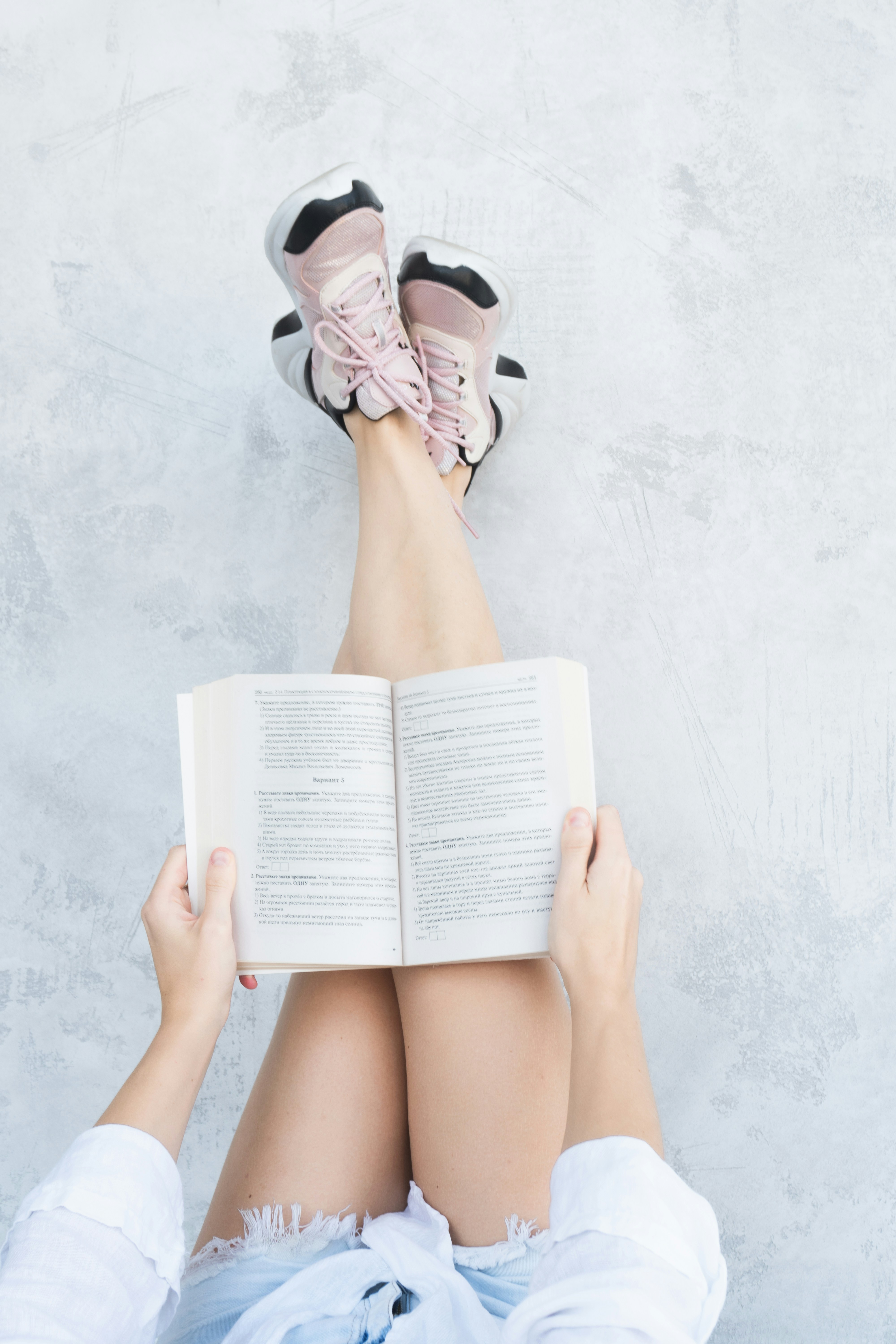 Another shot of woman with pink hair reading book
