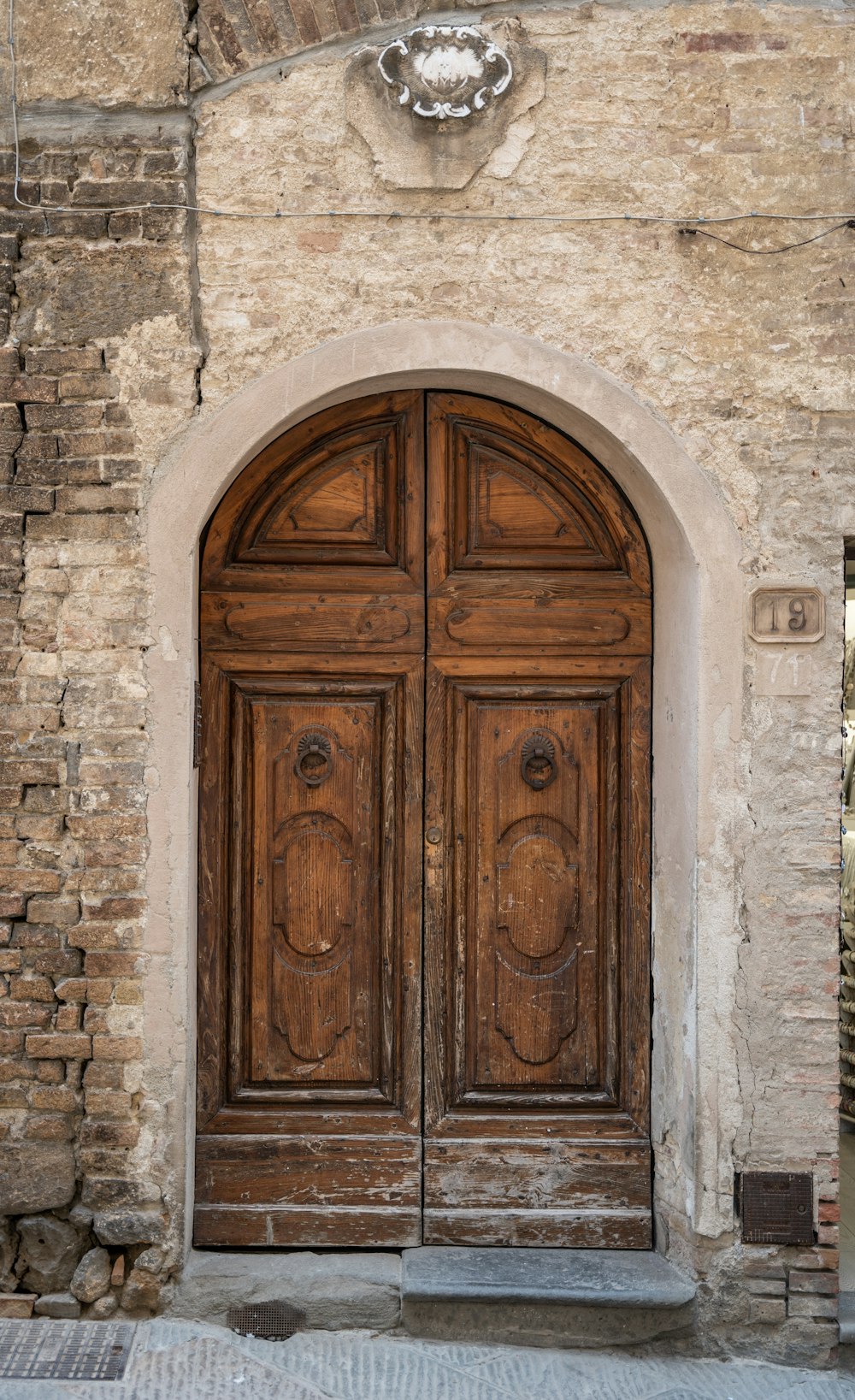 brown wooden door on gray concrete wall