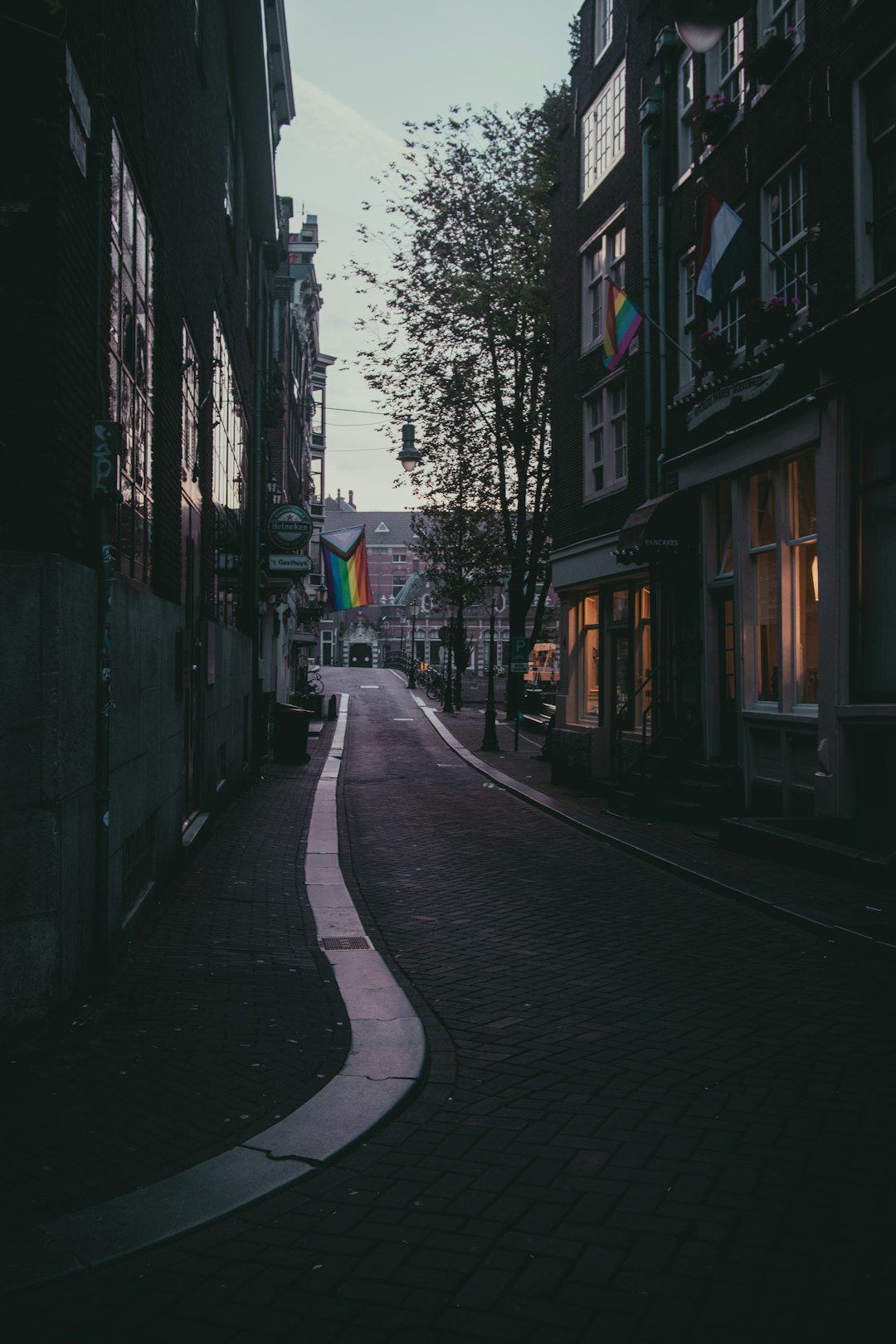 empty street in between buildings during daytime