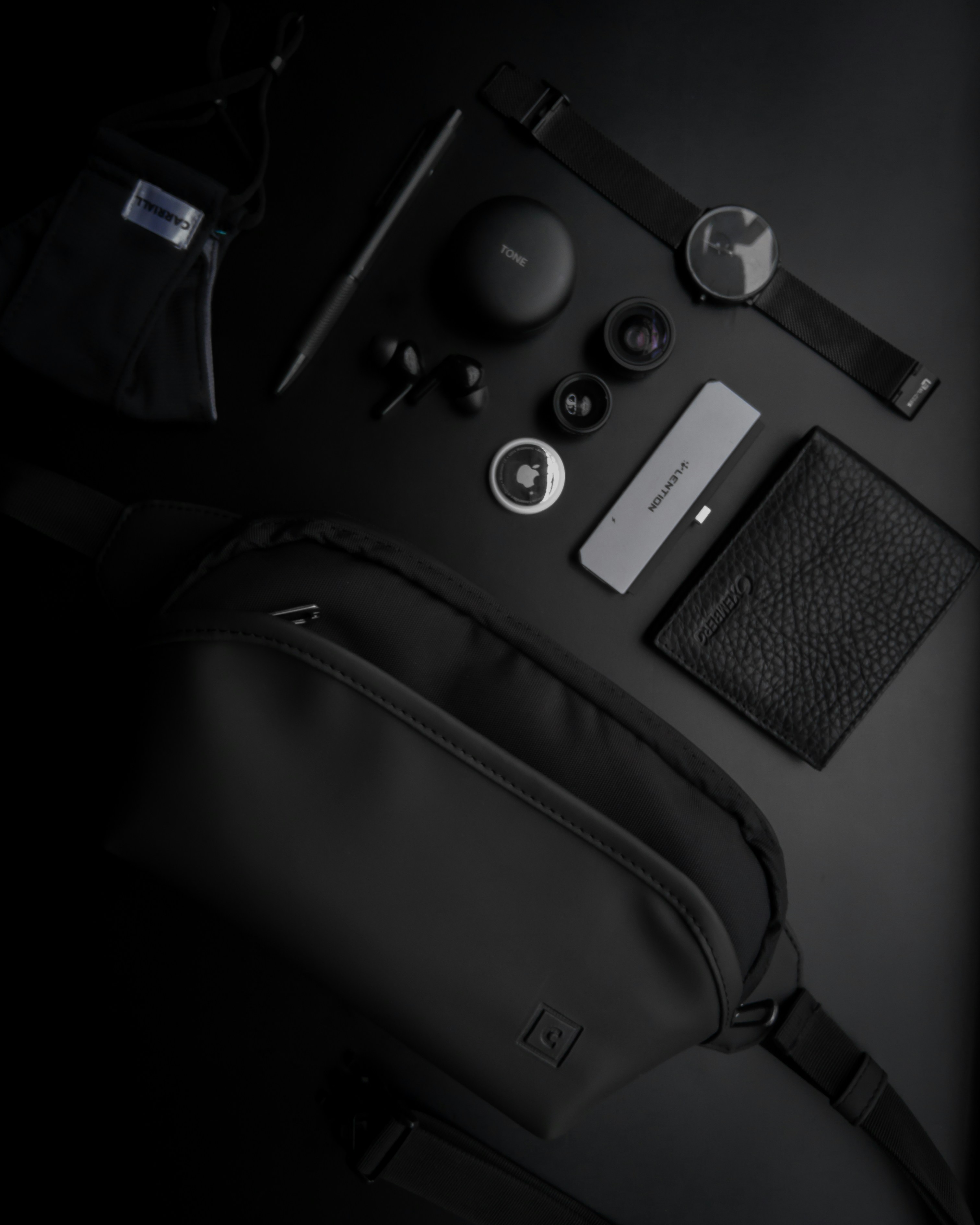 black and silver camera on black leather bag