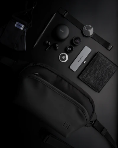 black and silver camera on black leather bag