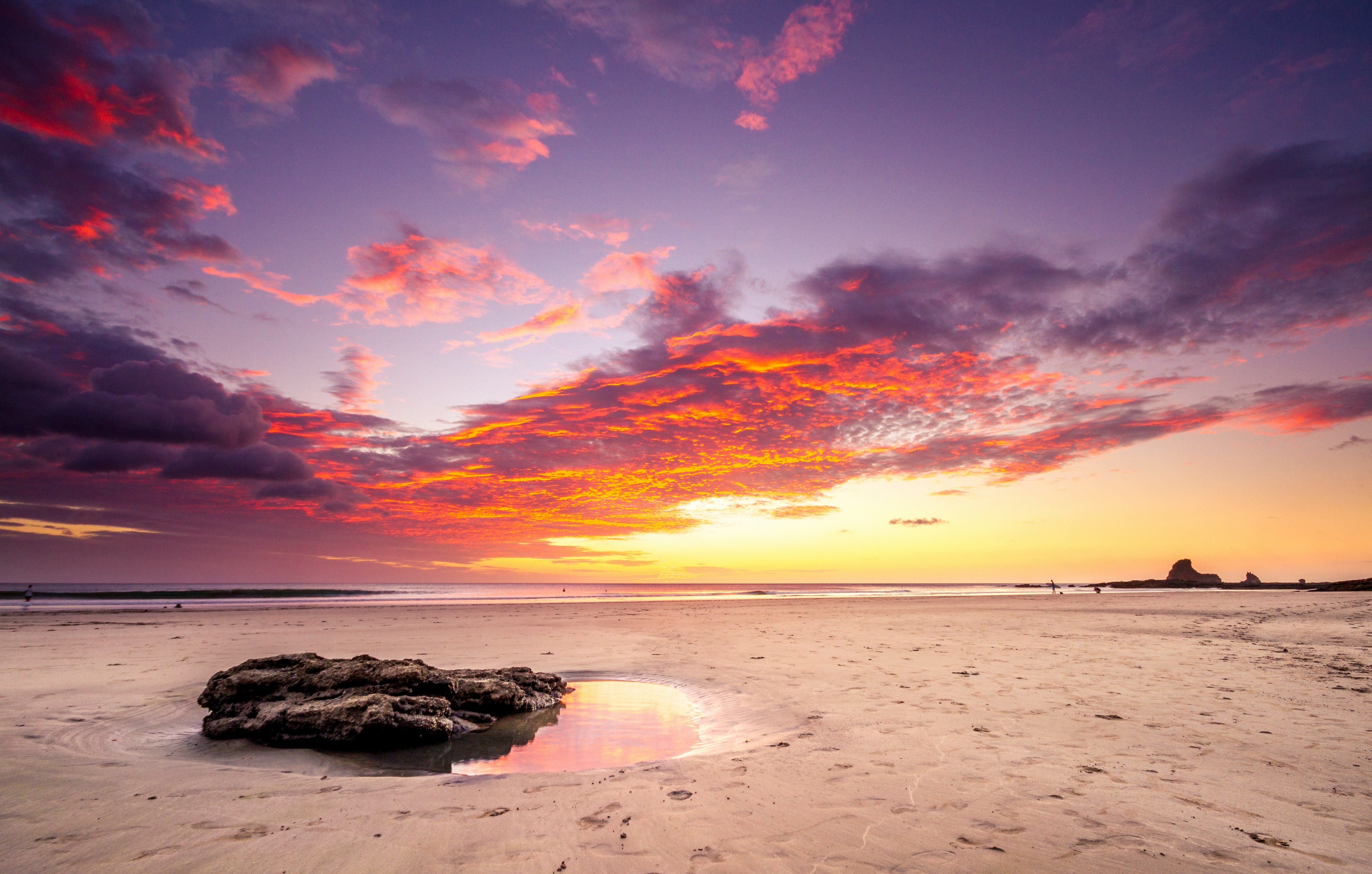 brown sand beach during sunset