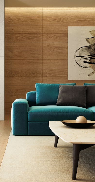 blue sofa beside brown wooden table
