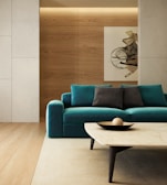 A sleek modern teak wood sofa set in a bright living room with neutral tones.