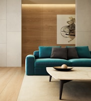 blue sofa beside brown wooden table